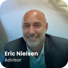 A smiling man in a suit sits in a softly lit, professional setting. Text on the image reads: "Eric Nielsen, Advisor.